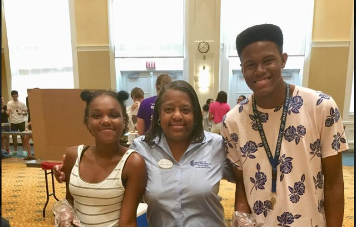 Director of The James Farmer Multicultural Center, Dr. Marion Sanford poses with UMW students at the annual Cross-Cultural BBQ