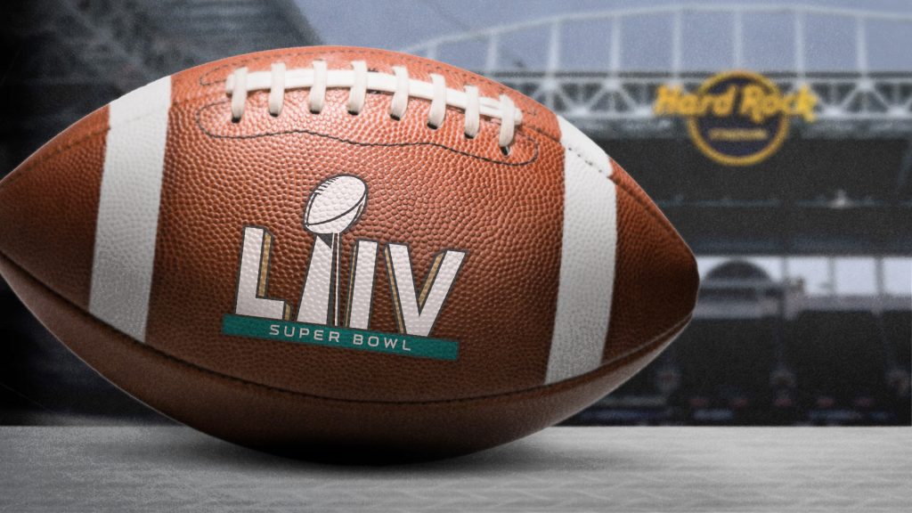 A football with LIV roman numerals on the football with hard rock stadium in the background