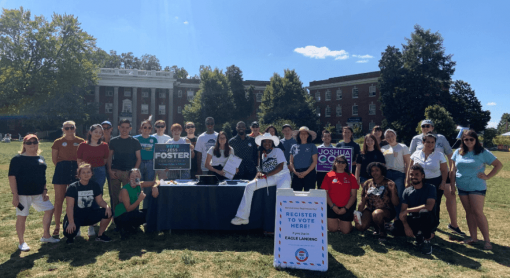 A group of students tabling on campus to help people register to vote.
