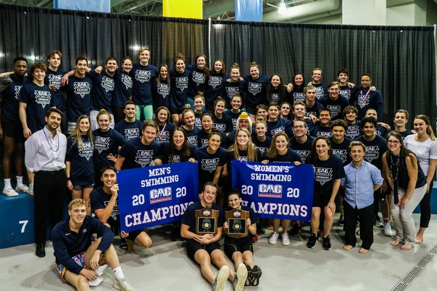 Both the men's and woman's swim team pose with their respective CAC championship banners with their coaches.