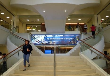 People walk on the staircase of the University Center.