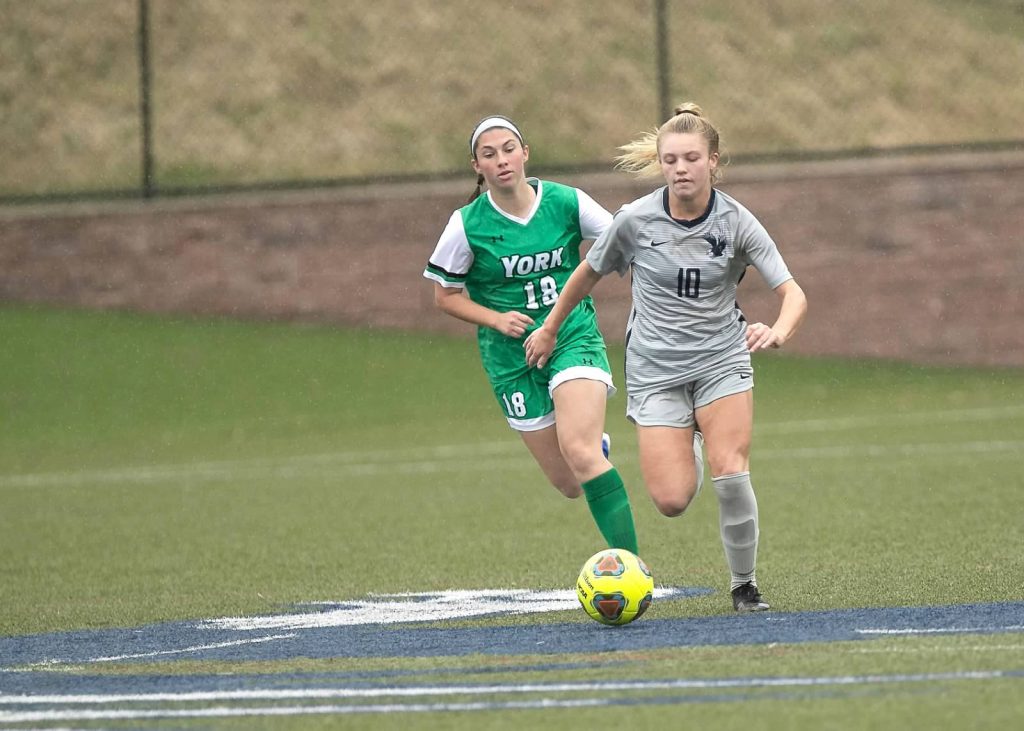 Katherine Brady drives the ball down the field in a match with York College.