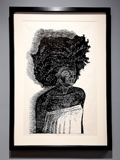 A balck and white portrait of a black woman with an afro.