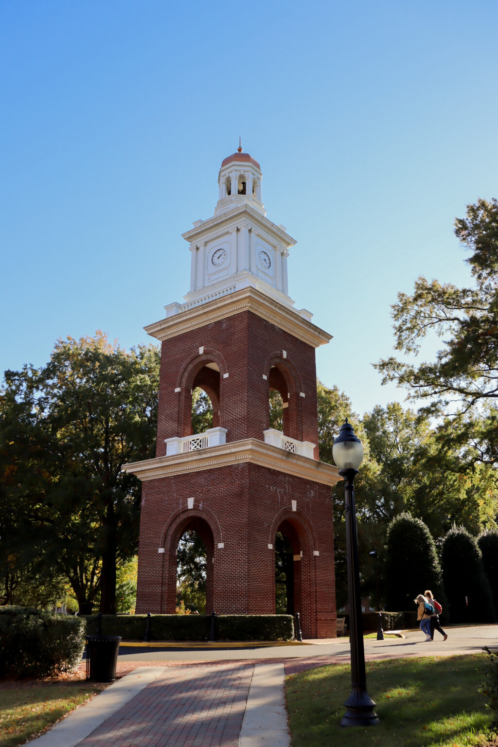 The Bell Tower, a tall building made of brick with a clock and bell at the top