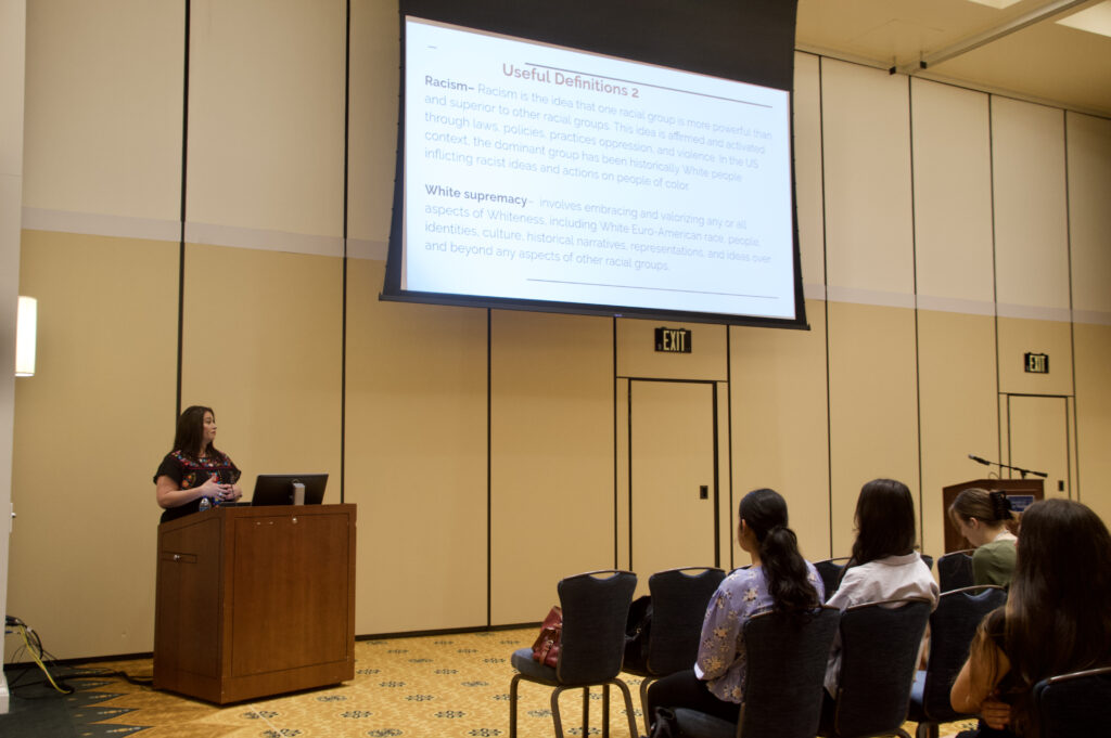 Dr. Rachel Gomez gives a presentation to a group of students.