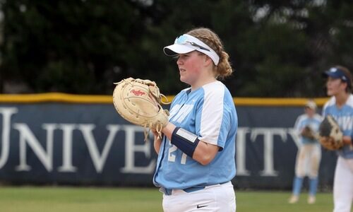 Female softball player in a light blue and white jersey.