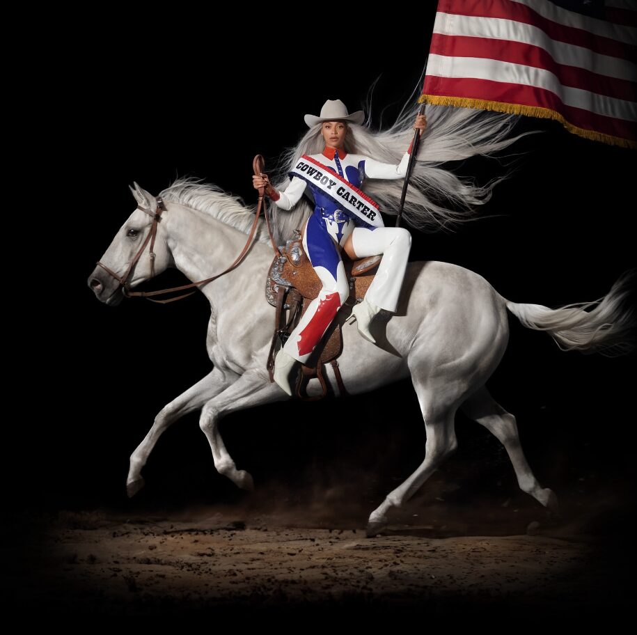Image of Beyoncé carrying the American flag, while riding a white horse.