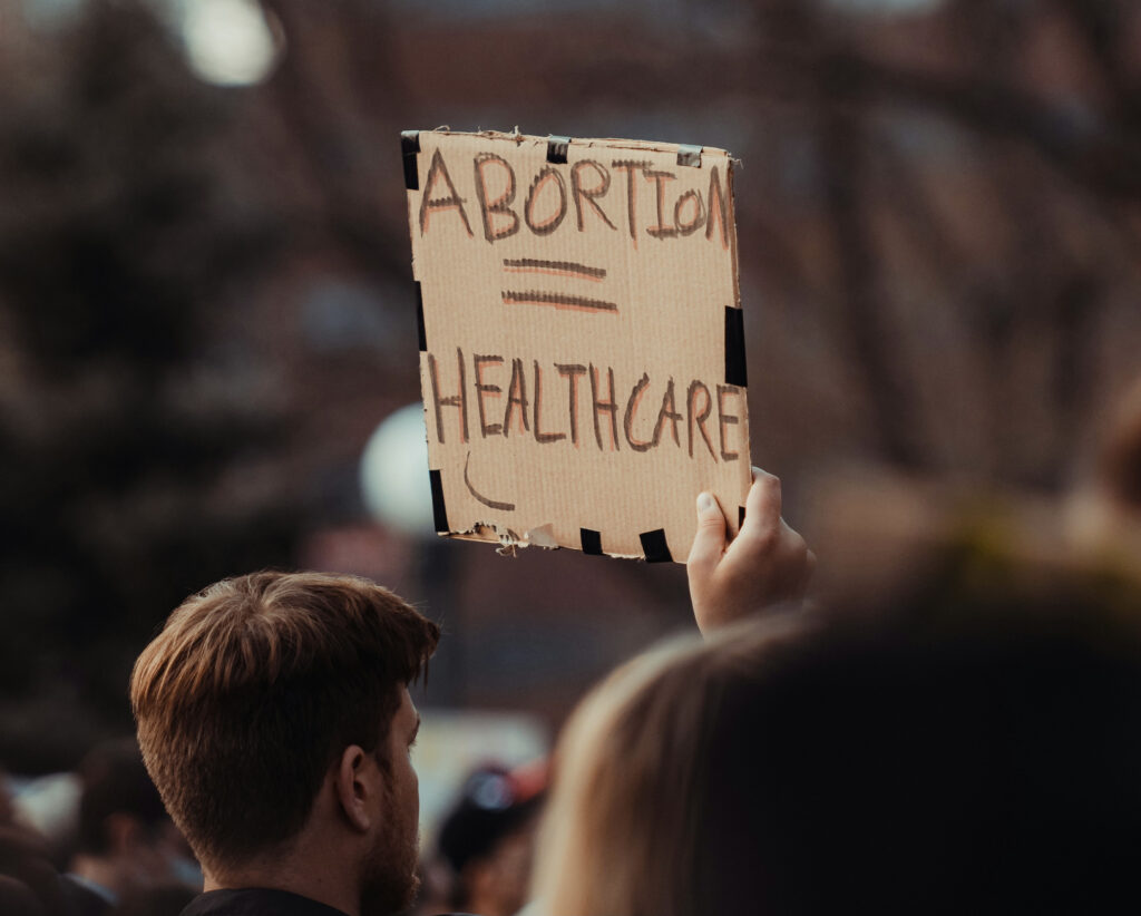 A man holding a sign engages in peaceful protest.